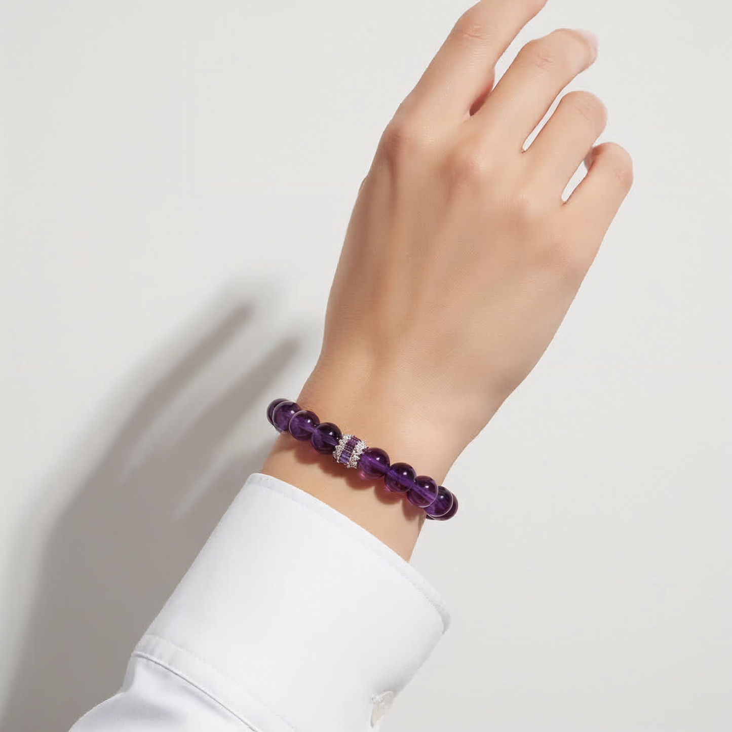 Woman wearing JWPatronus Royal Amethyst Bracelet – elegant purple gemstone jewelry