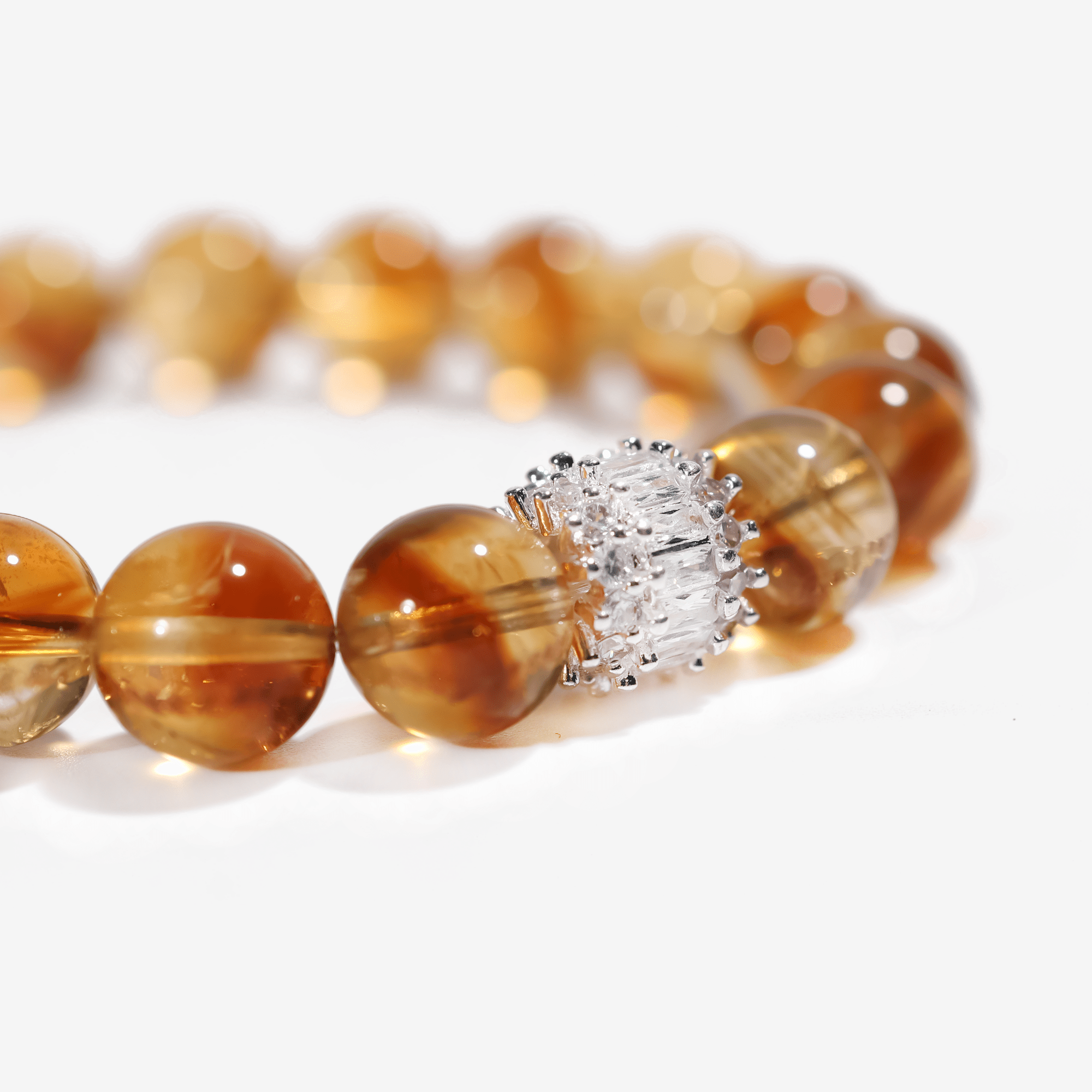 Close-up of 12mm Brazilian citrine gemstone beads with radiant golden glow