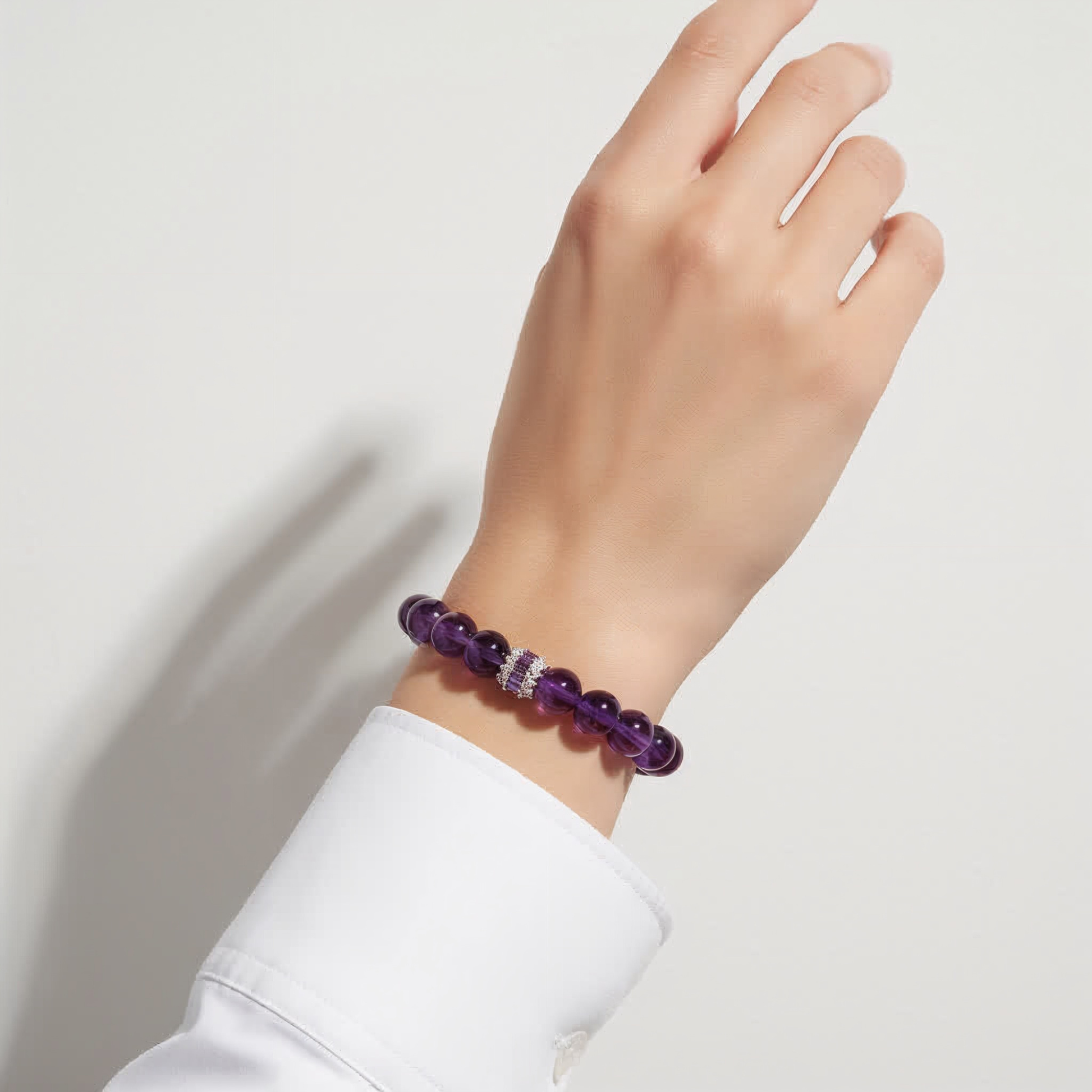 Woman wearing JWPatronus Royal Amethyst Bracelet – elegant purple gemstone jewelry