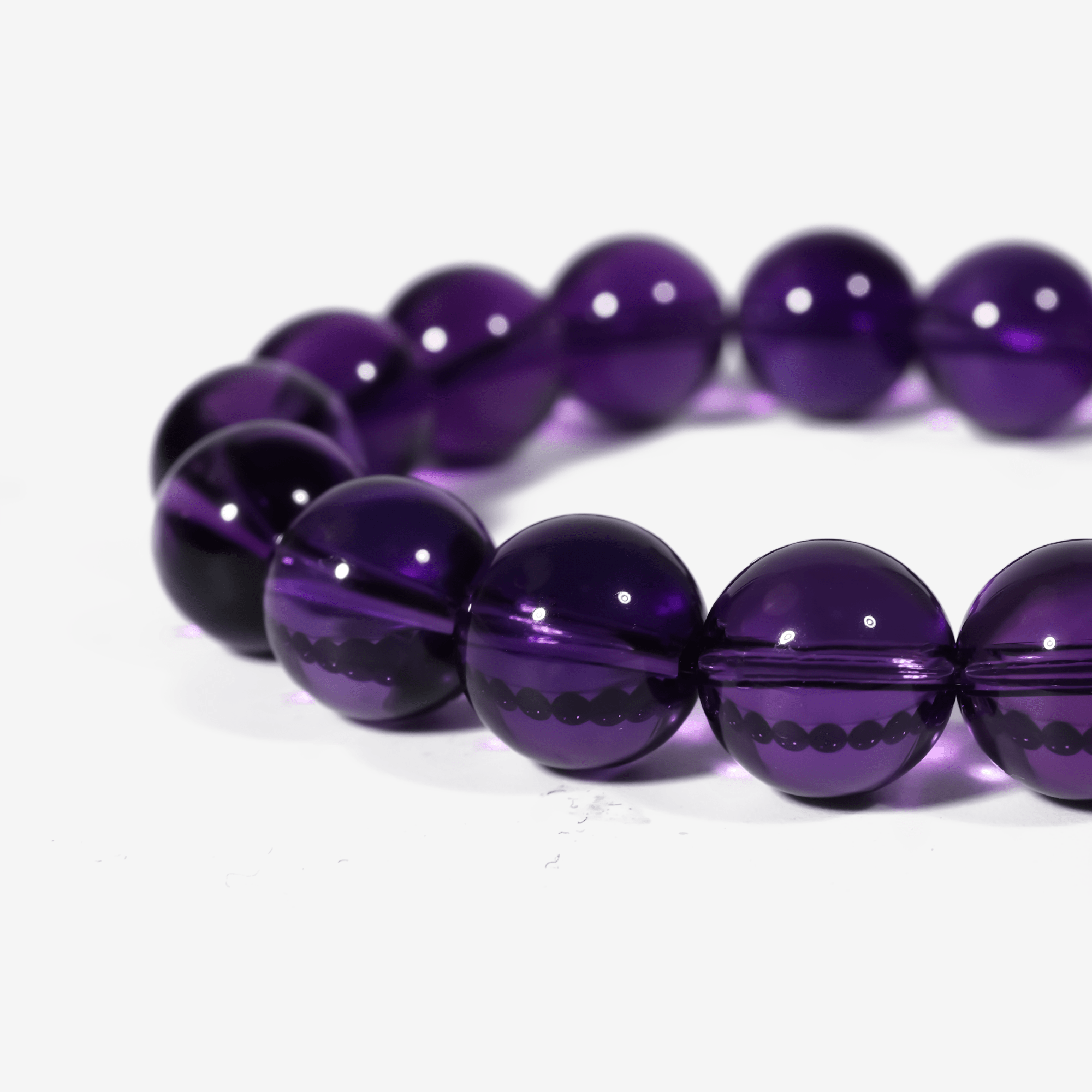 close up of polished Sri Lankan amethyst beads on an elegant purple crystal healing bracelet