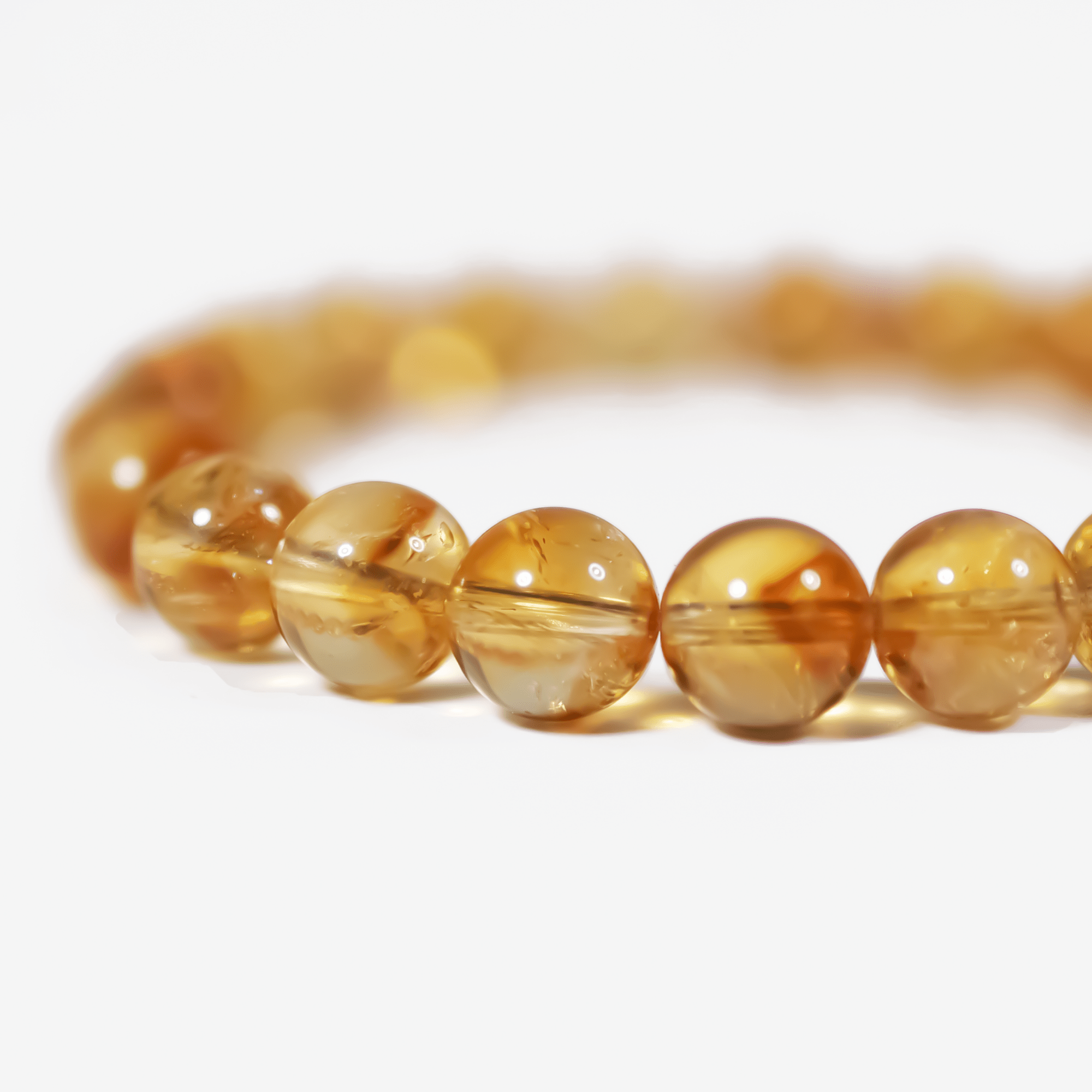 Citrine crystal bracelet detail showing soft golden glow and clarity