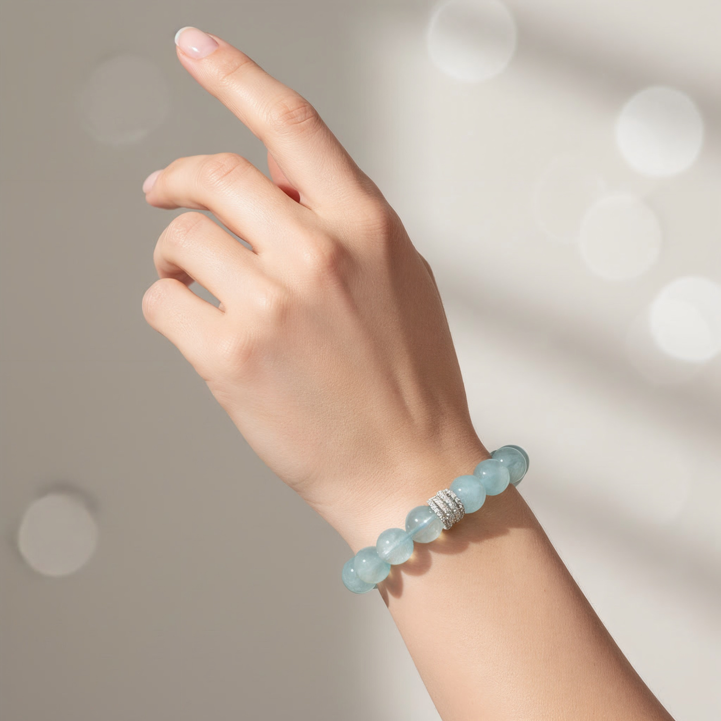 Aquamarine jewelry bracelet on wrist, 10mm beads, minimalist everyday style for women