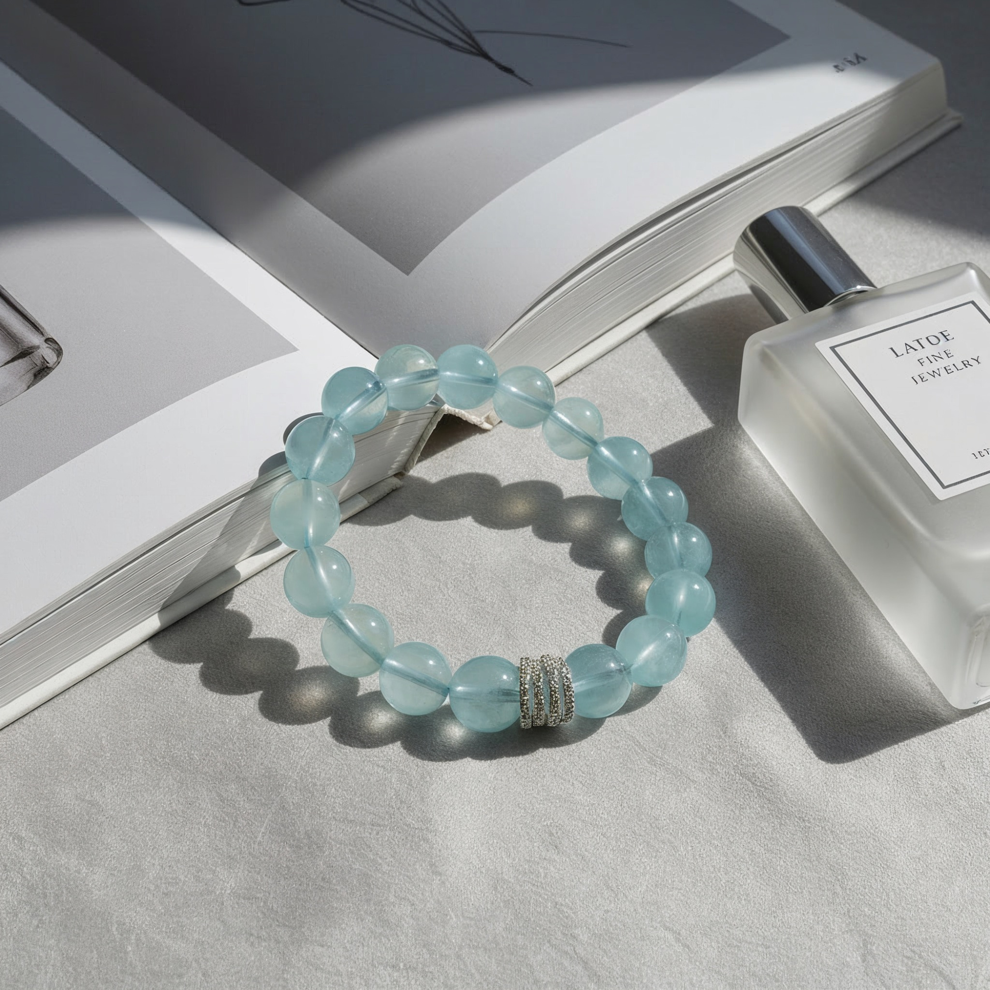 Ocean Calm aquamarine bracelet flat lay, March birthstone jewelry with 10mm beads and silver detail