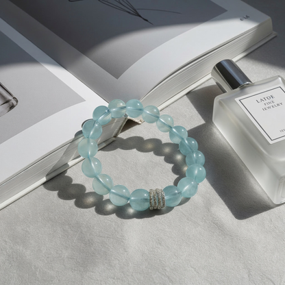 Ocean Calm aquamarine bracelet flat lay, March birthstone jewelry with 10mm beads and silver detail
