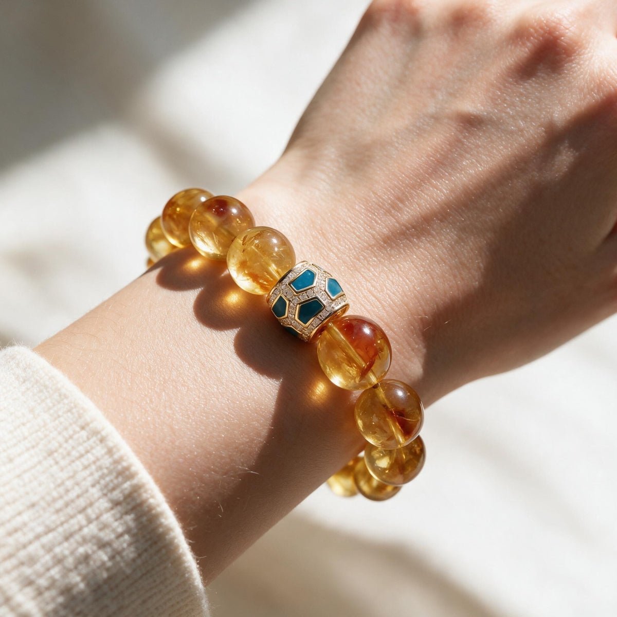 Amber Glow Citrine Bracelet styled with a cream knit sleeve for polished everyday wear.