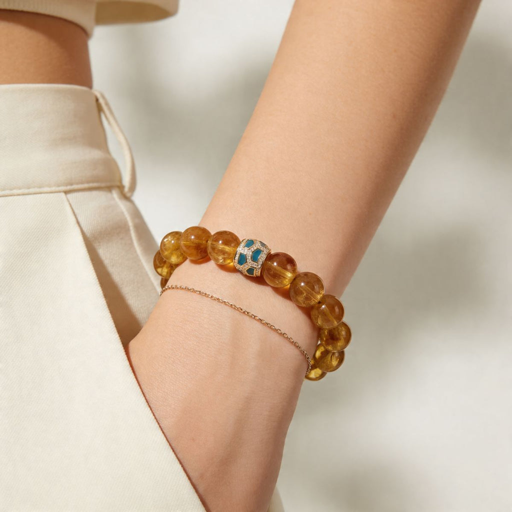 Gold citrine bracelet for women with 12mm beads worn in soft natural light