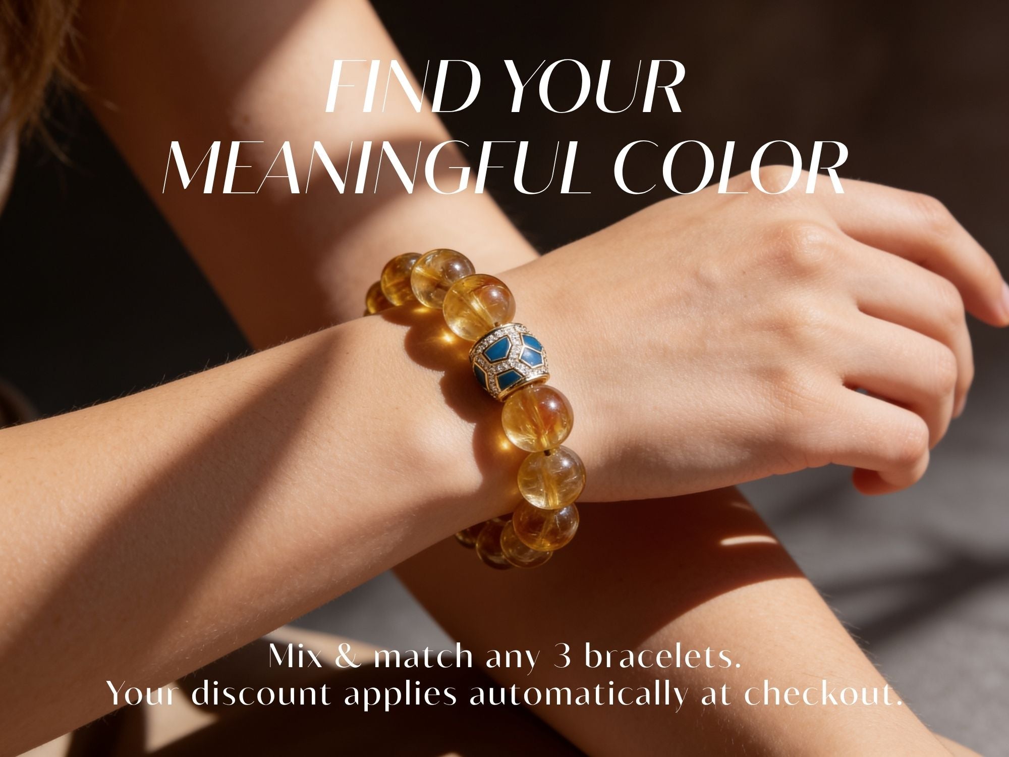 Close-up of the Amber Glow natural Brazilian citrine and green agate bracelet worn on a woman’s wrist