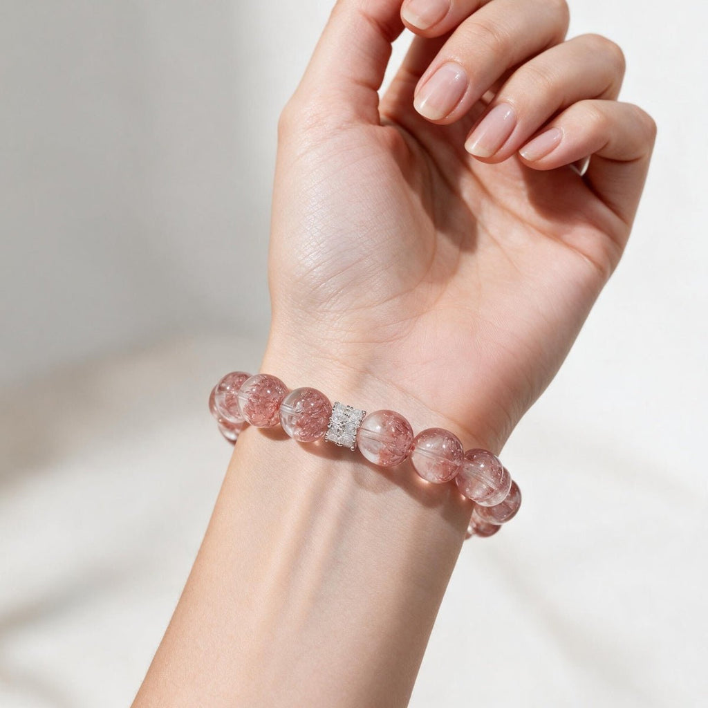 Aurora Bloom Strawberry Quartz bracelet on the wrist, showing its rosy-pink color and statement 12mm beads.