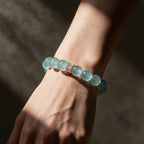 Blue Horizon Gold Baguette aquamarine bracelet worn on a woman’s wrist in natural light