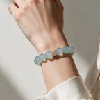 Blue Horizon Gold Pavé Stack aquamarine bracelet styled with a cream sleeve for everyday wear