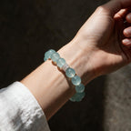Woman wearing the Blue Horizon Silver Halo aquamarine bracelet with a white sleeve