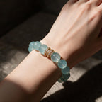 Blue Horizon Gold Pavé Stack aquamarine bracelet worn on a woman’s wrist in warm natural light