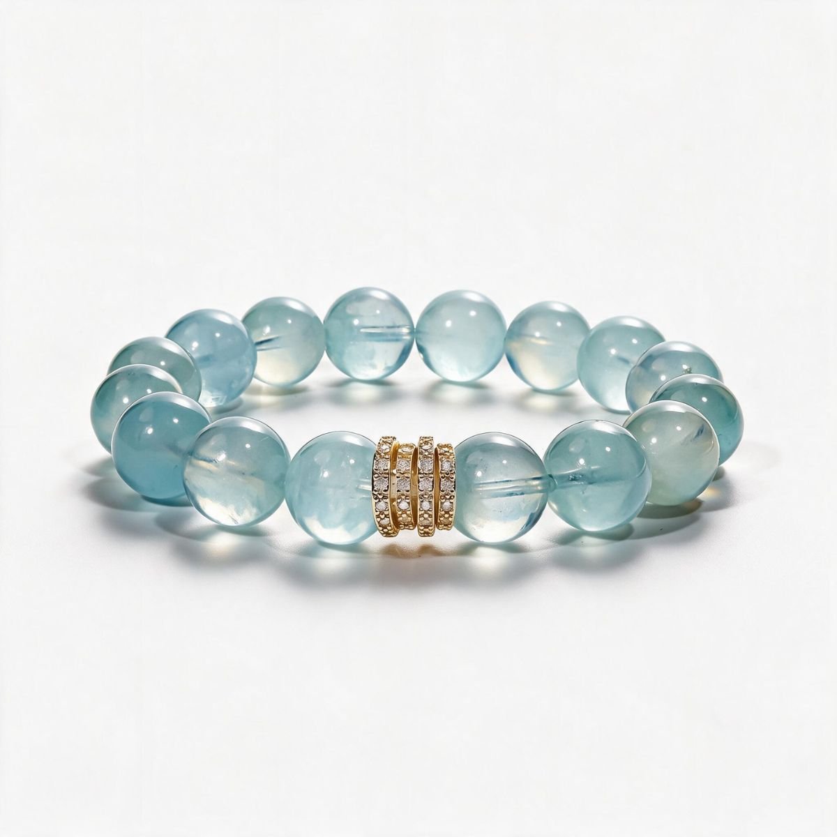 Blue Horizon natural aquamarine bracelet with 12mm ocean-blue beads and a Gold Pavé Stack centerpiece