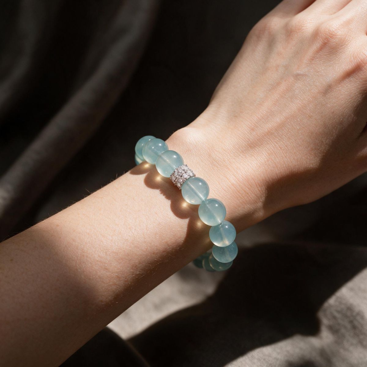 Blue Horizon Silver Halo aquamarine bracelet worn on a woman’s wrist in natural light