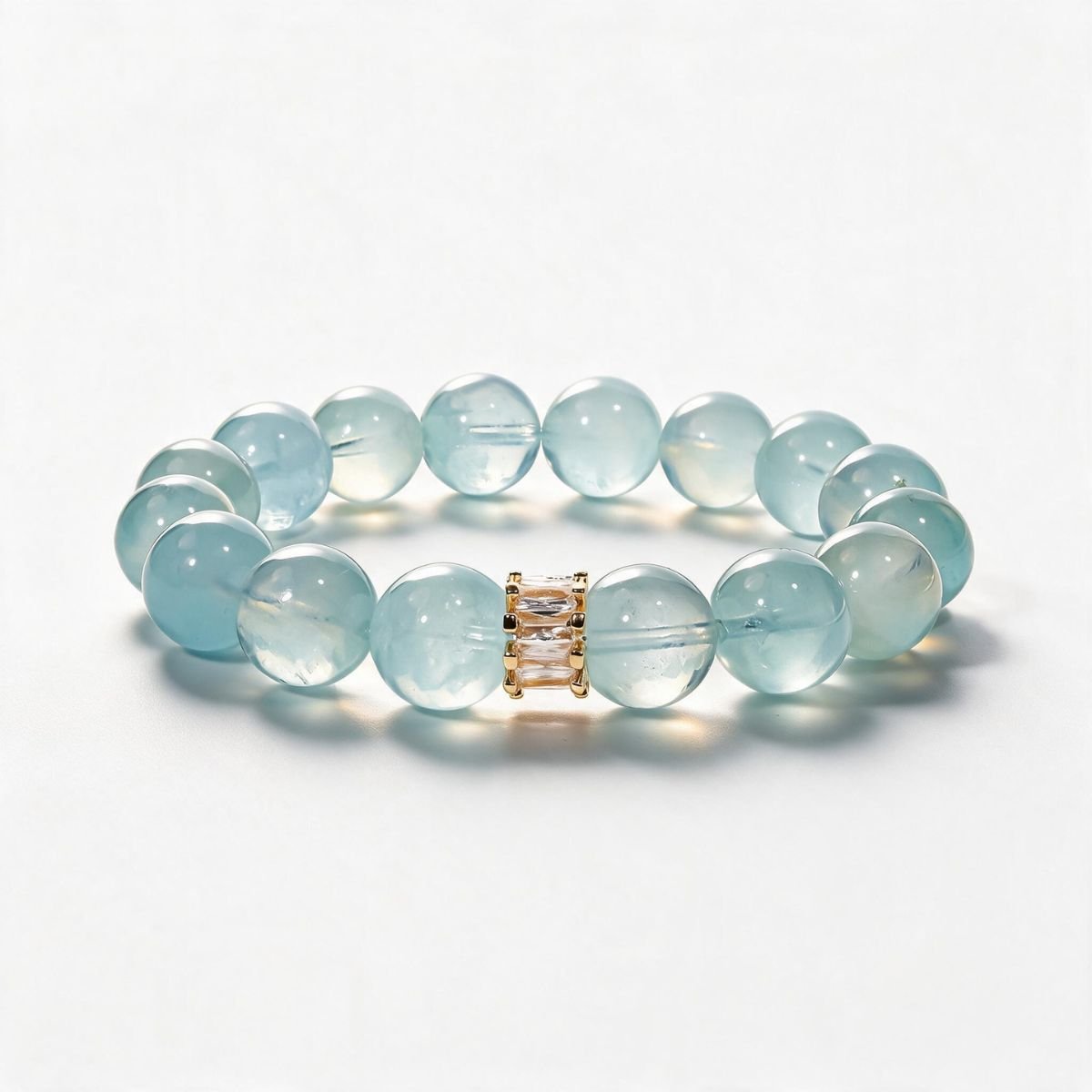 Blue Horizon natural aquamarine bracelet with 12mm ocean-blue beads and a Gold Baguette centerpiece