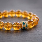 Close-up of Brazilian Citrine bracelet with Mosaic Green Inlay centerpiece and golden beads