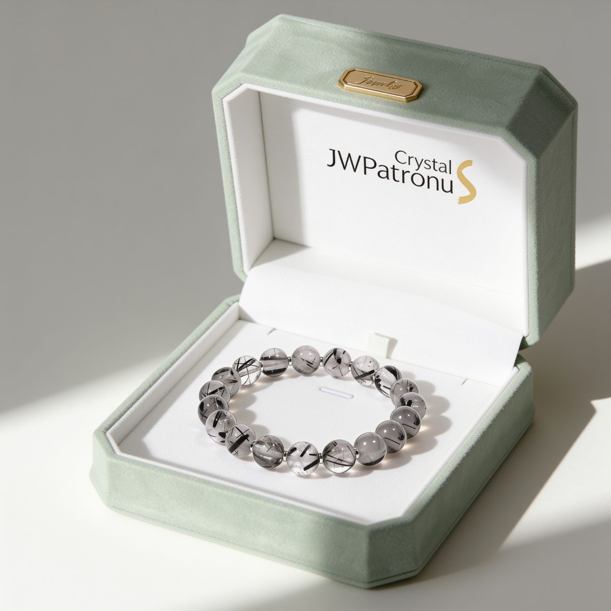 Gift-ready Calm Armor Black Rutilated Quartz Bracelet presented in a JWPatronus jewelry box with natural rutile-patterned beads.