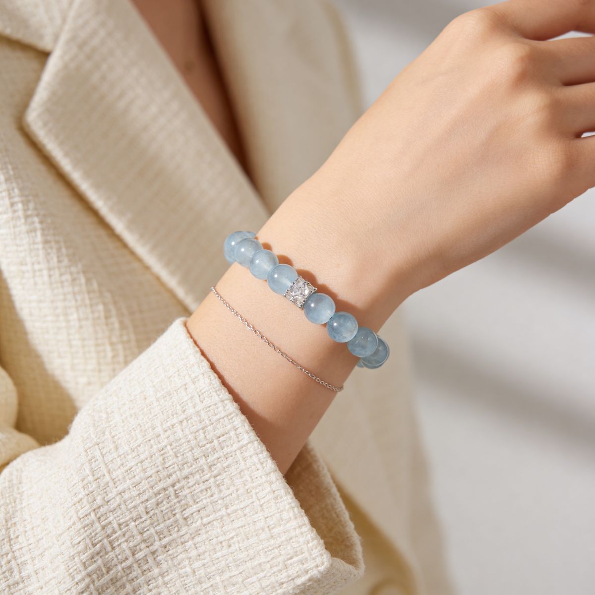 10mm aquamarine bracelet worn with cream sweater for everyday styling