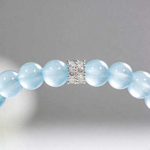 Close-up of aquamarine beaded bracelet with blue natural stone beads and cubic zirconia detail