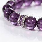 Close-up of the sterling silver centerpiece and hand-polished 10mm Amethyst beads on the Eternal Elegance bracelet.