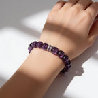 Natural Sri Lankan Amethyst bracelet with 10mm violet beads worn on a woman’s wrist in sunlight.
