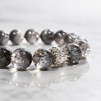 Close-up of natural Silver Phantom Quartz beads showing silver-gray tones, translucency, and natural inclusions