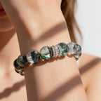 Woman wearing Forest Veil Green Phantom Quartz Beaded Bracelet with deep green phantom patterns