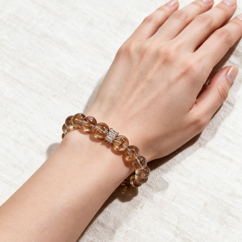 Fortune Koi Hematoid Quartz bracelet worn on the wrist with warm neutral everyday styling