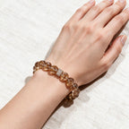 Fortune Koi Hematoid Quartz bracelet worn on the wrist with warm neutral everyday styling
