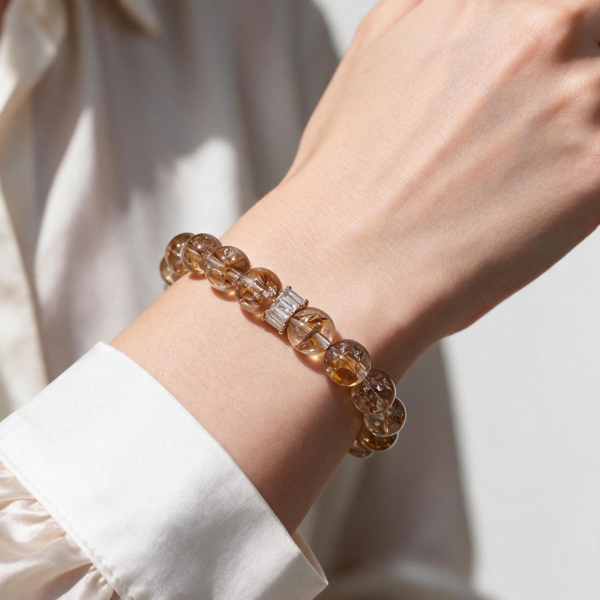 Fortune Koi Hematoid Quartz bracelet styled with a white shirt for a refined everyday look