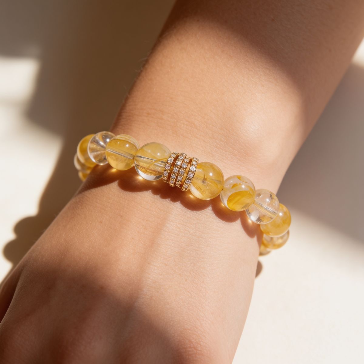 Woman wearing Golden Blossom Yellow Quartz Beaded Bracelet with warm golden 10mm beads
