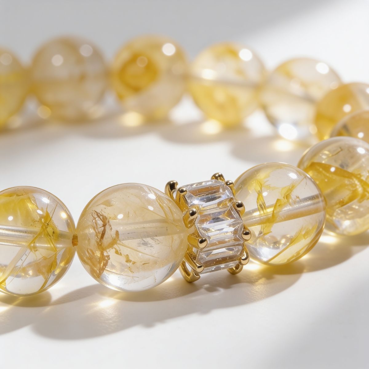 Close-up of Golden Healer Yellow Quartz Bracelet showing clear yellow quartz beads, golden natural inclusions, and baguette crystal bar accent