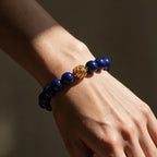 Golden Lucky Lapis Bracelet worn on the wrist in warm directional light.