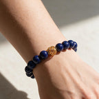 Golden Lucky Lapis Bracelet styled on the wrist in bright natural light.