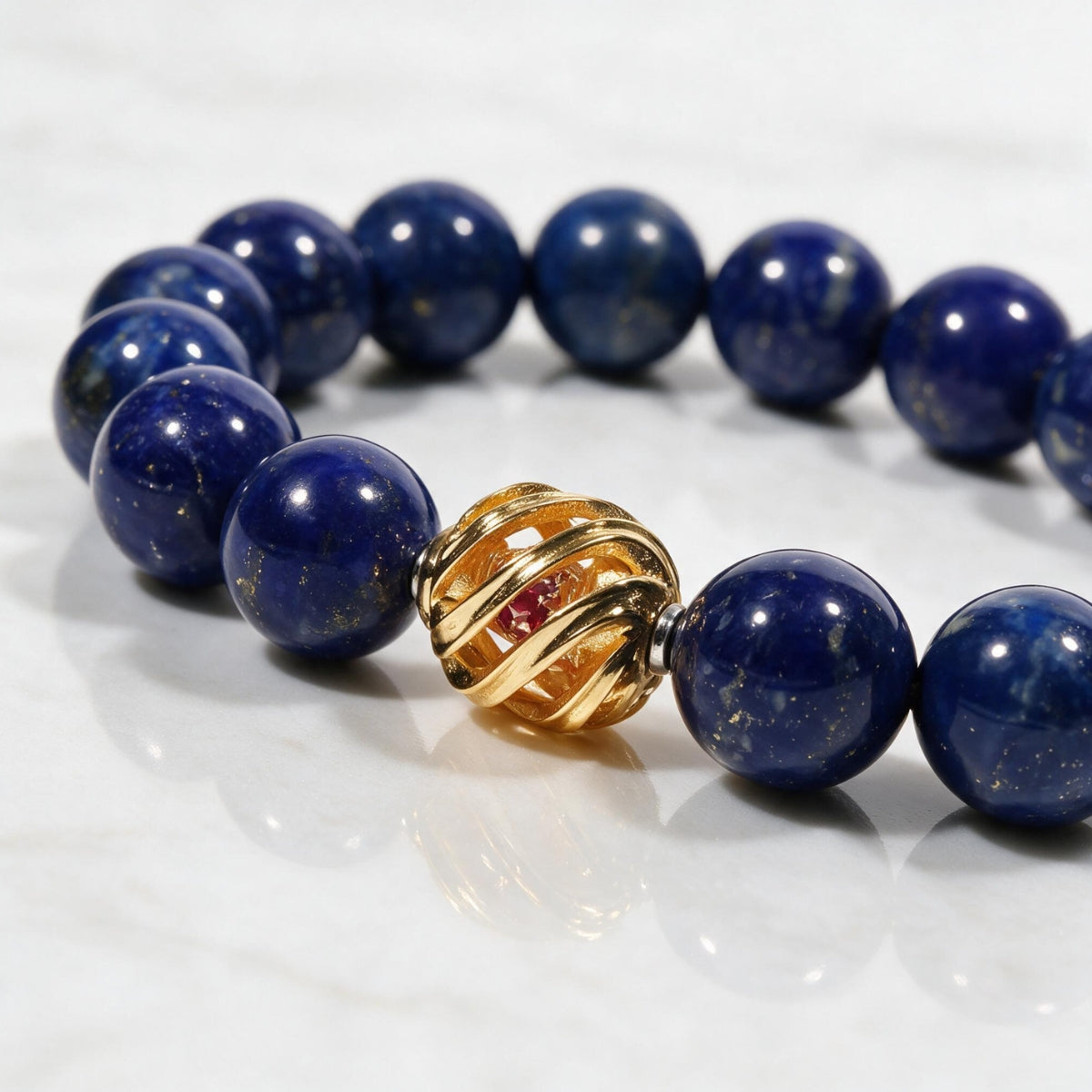 Close-up of royal-blue lapis lazuli beads, natural pyrite flecks, and the 14K gold-plated centerpiece.