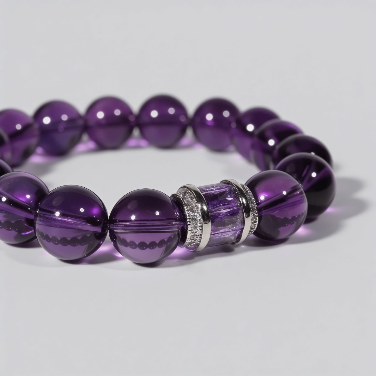 Close-up of Graceful Amethyst Poise Bracelet showing rich violet amethyst beads and sterling silver centerpiece with faceted amethyst inlay