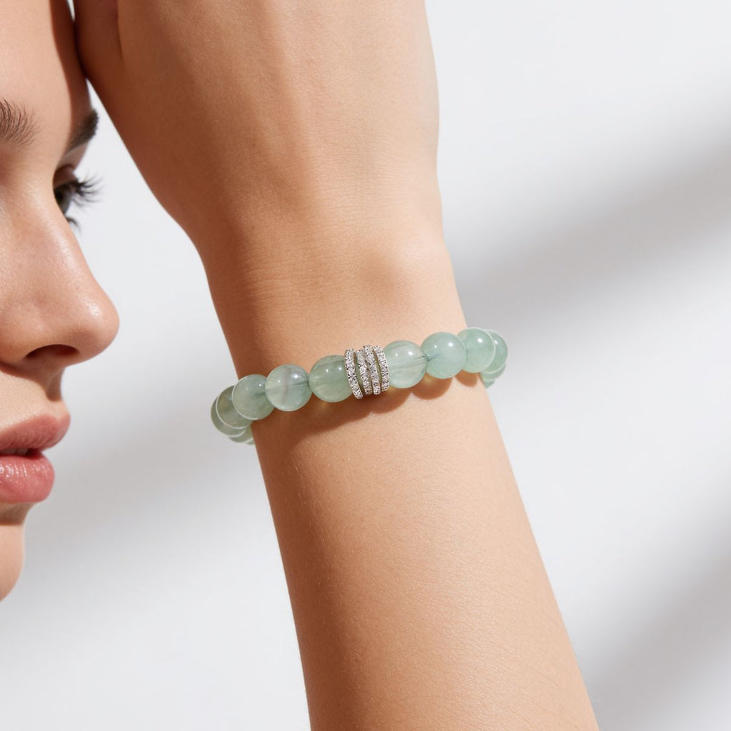 Natural Green Fluorite beaded bracelet styled on a woman’s wrist with soft feminine everyday jewelry look