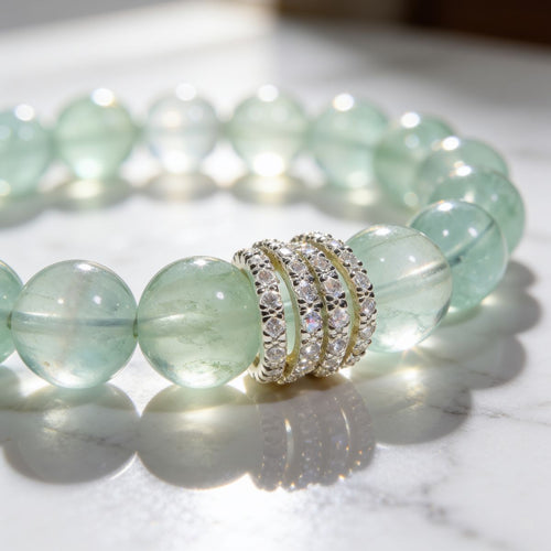 Close-up of natural Green Fluorite bracelet with translucent 10mm beads and silver-tone cubic zirconia ring detail