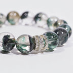 Close-up of Green Phantom Quartz beaded bracelet with clear 12mm beads and sparkling pavé ring centerpiece