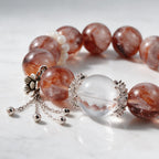 Close-up of natural Hematoid Quartz beads with vivid red mineral inclusions and sterling silver details