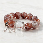 Natural Fire Quartz bracelet showing clear quartz beads, red mineral inclusions, and polished silver accents
