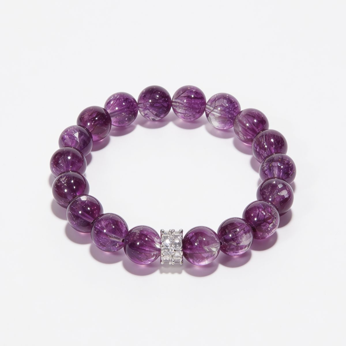 Top view of Inner Grace Amethyst Bracelet featuring natural Super Seven Amethyst beads and a sterling silver centerpiece
