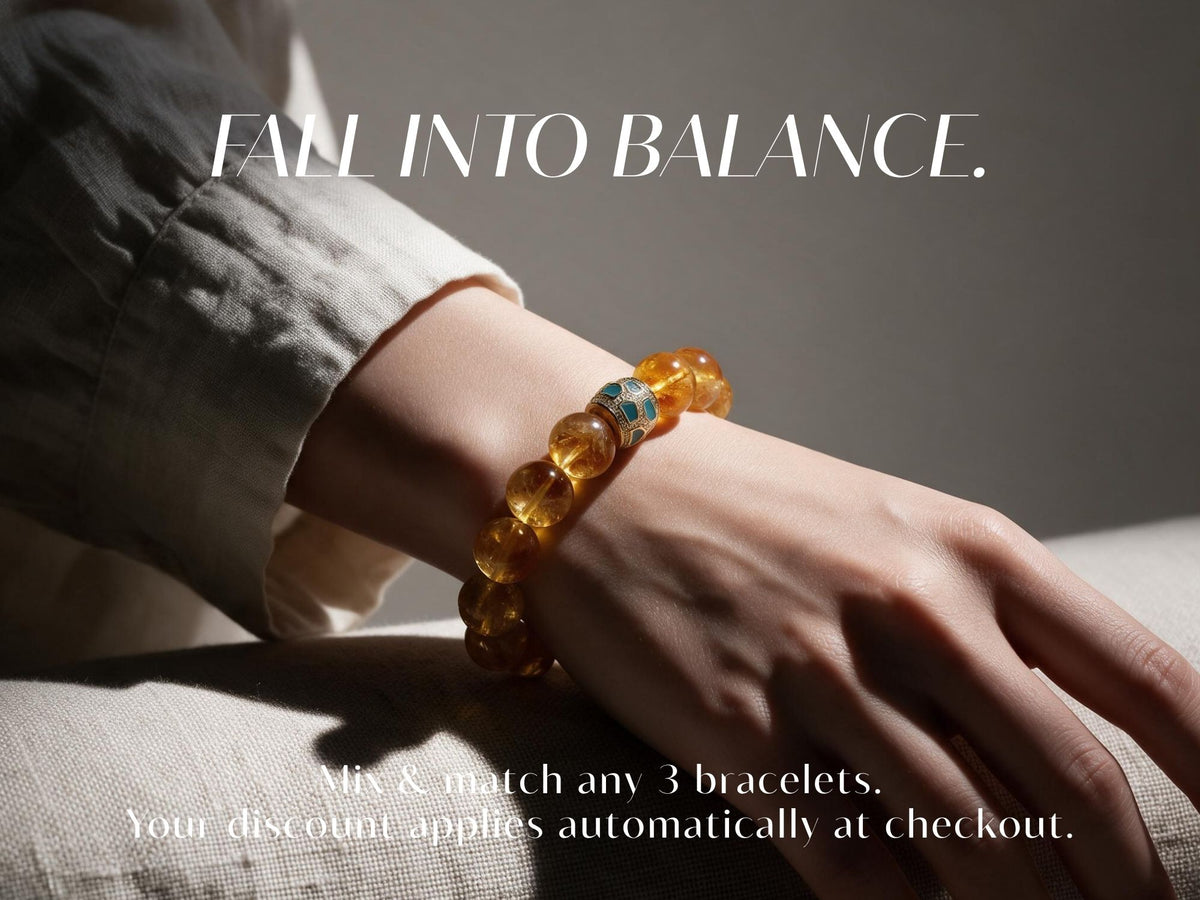 Fall Into Balance: close-up of a golden gemstone bracelet on a woman's wrist. Mix and match any three bracelets; the discount applies automatically at checkout.