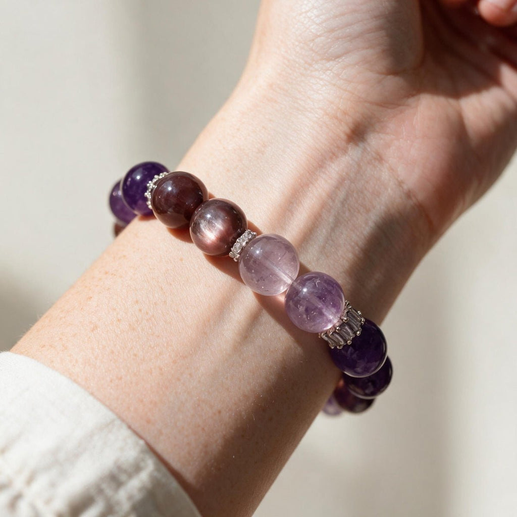 Lunar Grace purple gemstone bracelet worn with a cream sleeve, showing lilac, mauve, and violet natural beads