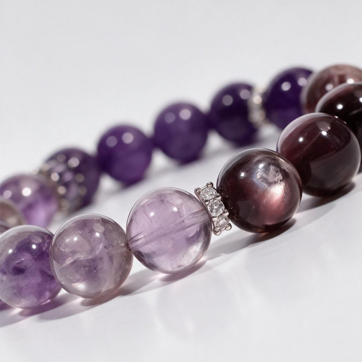 Close-up side view of the Lunar Grace bracelet with purple amethyst, marbled lepidolite, and silver moon detail