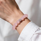 Blush-pink Rose Quartz bracelet styled with a white sleeve for everyday wear