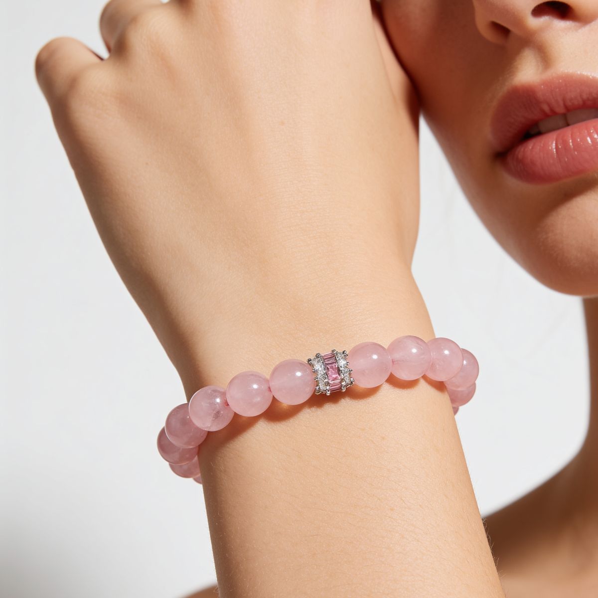 Natural Madagascar Rose Quartz bracelet showing soft blush-pink tone, translucency, and a pink baguette-style centerpiece.