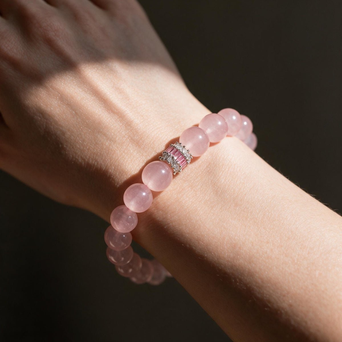 Madagascar Rose Quartz bracelet worn on the wrist in warm natural light