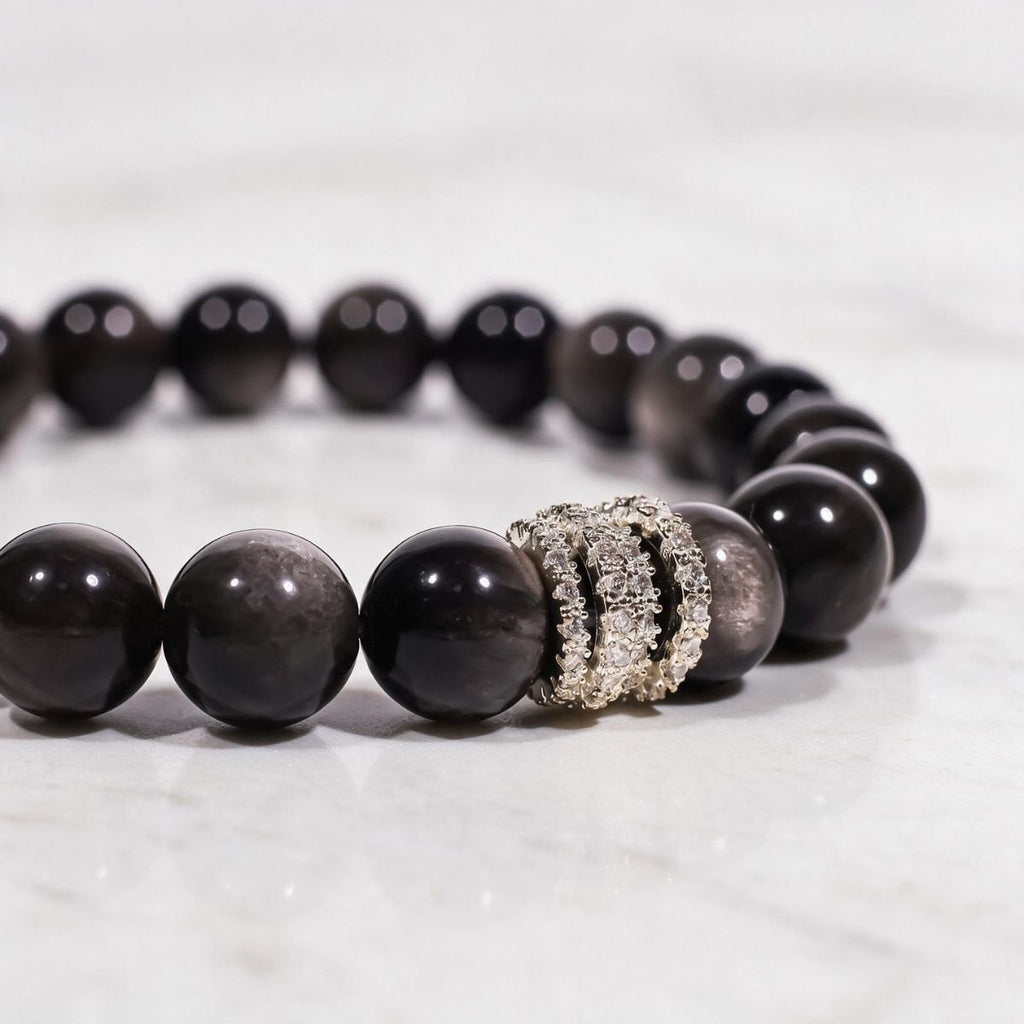 Close-up of hand-polished Silver Sheen Obsidian beads and the silver-tone pavé ring detail.