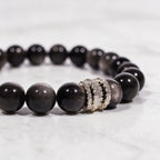 Close-up of hand-polished Silver Sheen Obsidian beads and the silver-tone pavé ring detail.